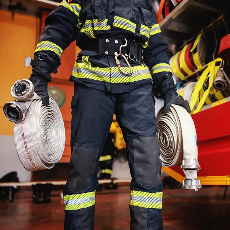 firefighter checking hoses in fire station